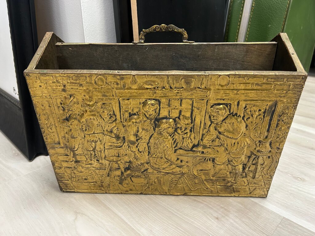 vintage wood-clad magazine rack featuring an embossed brass panel with a traditional pub scene.