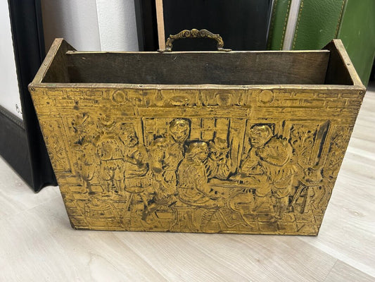 vintage wood-clad magazine rack featuring an embossed brass panel with a traditional pub scene.