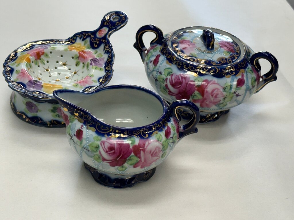 Hand-painted Japanese porcelain sugar, creamer, and strainer set.